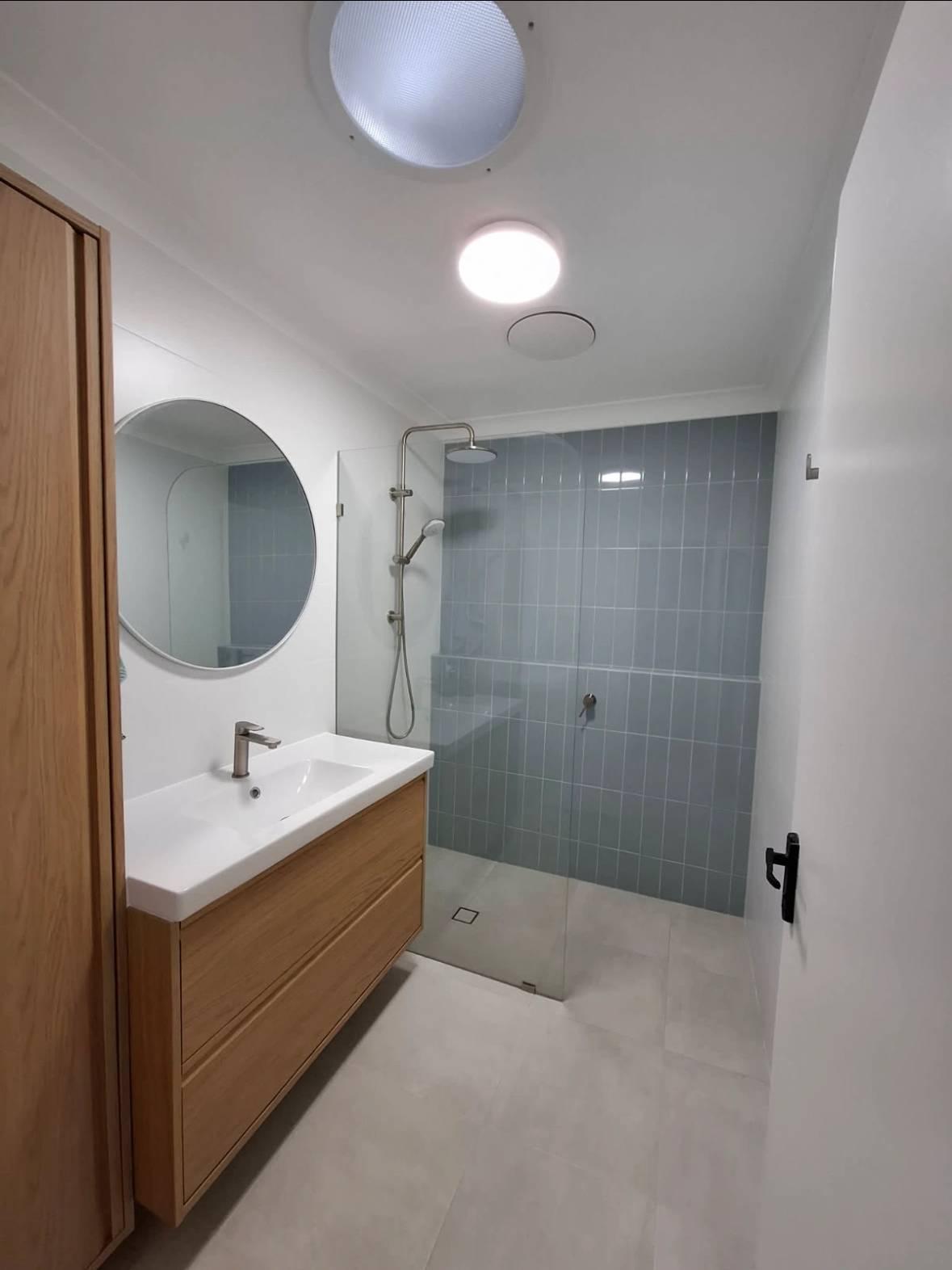Contemporary bathroom with walk-in shower and modern amenities